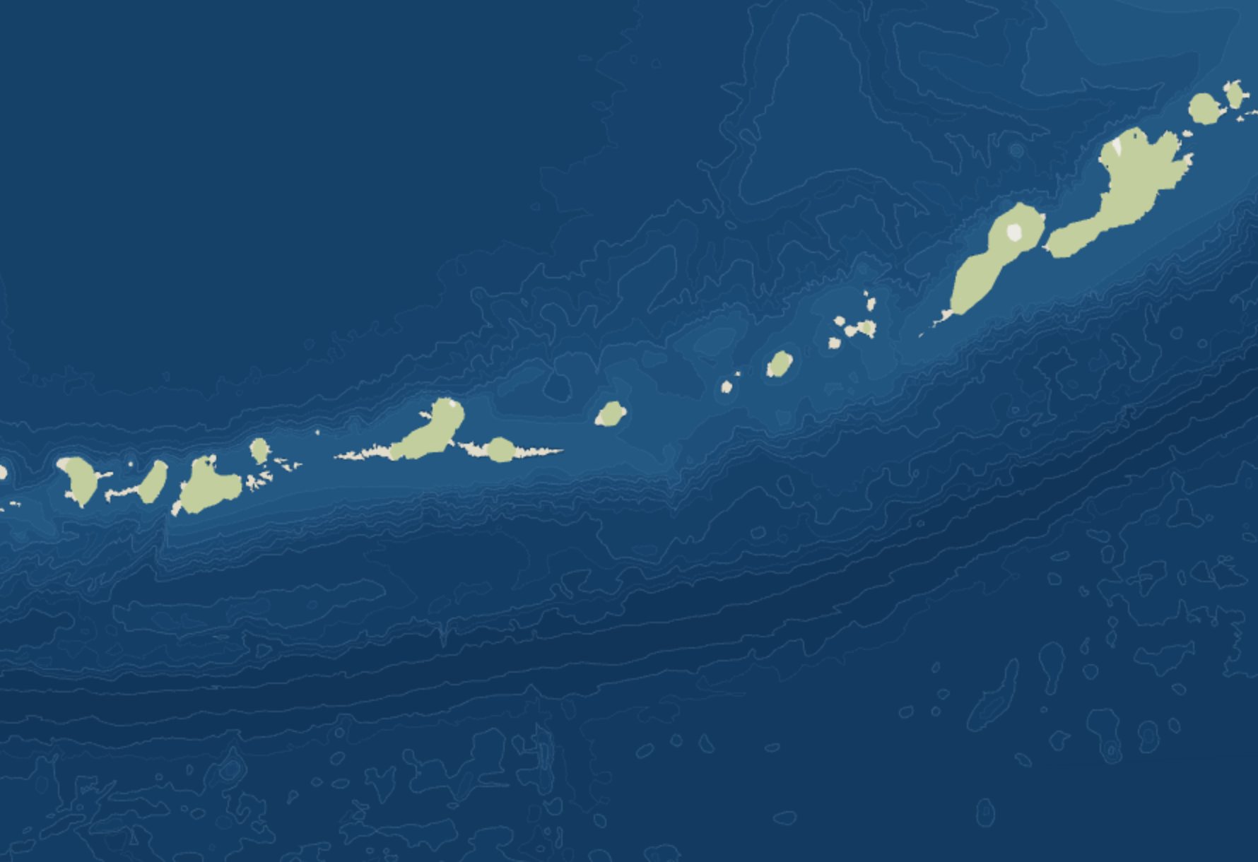 The Aleutian Islands at close zoom: contour lines bunch tightly along the Aleutian Trench to the south, where the seafloor drops to the deepest bands.